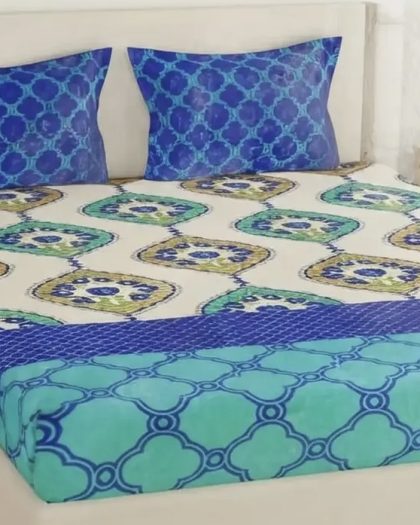 Blue and green geometric printed bedsheet set with decorative patterns and matching blue pillow covers.