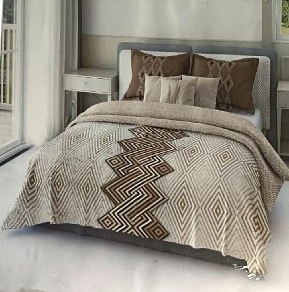 Elegant beige and brown geometric patterned bedspread with matching decorative pillows