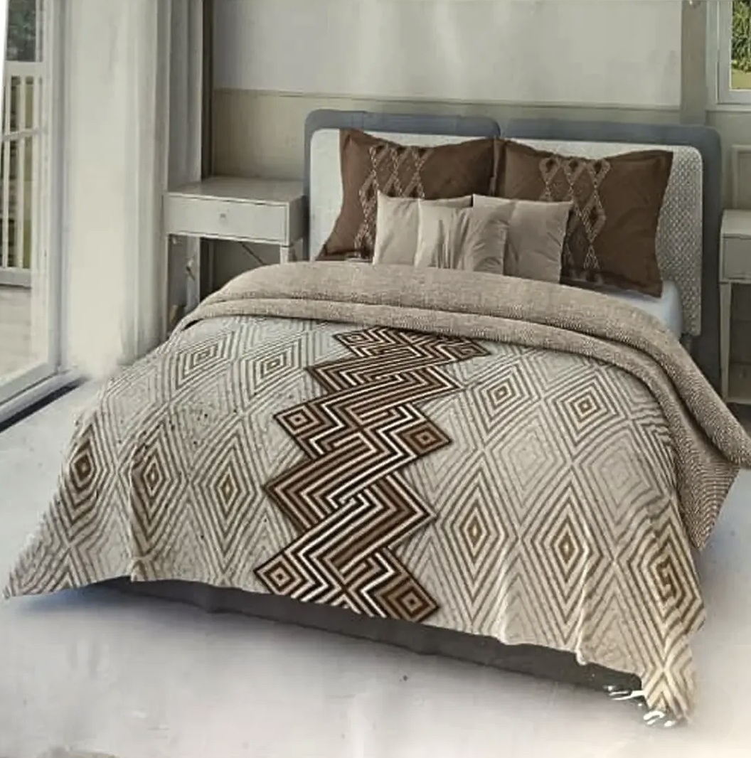 Elegant beige and brown geometric patterned bedspread with matching decorative pillows