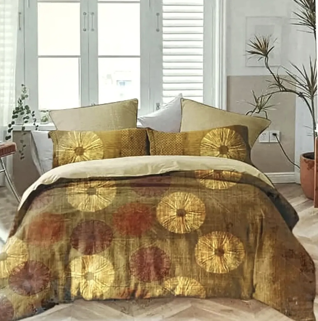 Elegant golden and brown bedspread with artistic circular floral patterns and matching decorative cushions