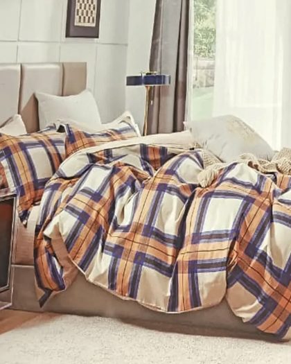 Navy blue, orange and beige plaid checkered cotton bedding set with duvet cover and pillow shams on upholstered bed