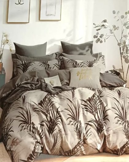 Taupe and dark brown palm leaf printed cotton bedding set with matching pillow shams and decorative cushions