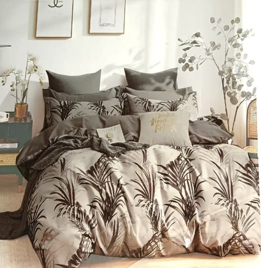 Taupe and dark brown palm leaf printed cotton bedding set with matching pillow shams and decorative cushions