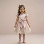 Blush pink satin party dress for toddler girls with big bow, lace hem and puff sleeves