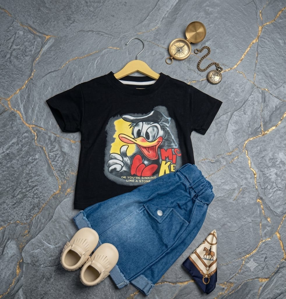 Black graphic T-shirt for kids with colorful cartoon duck print paired with blue denim jeans